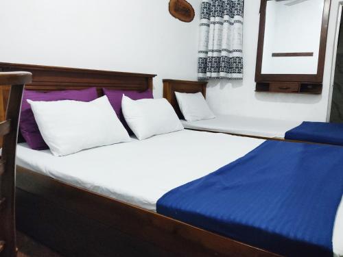 Ένα ή περισσότερα κρεβάτια σε δωμάτιο στο Green Holiday Inn