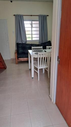 a living room with a table and a couch at La Palmera in Chajarí