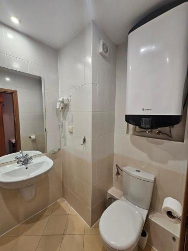 a bathroom with a toilet and a sink at Cozy studio 125 in Villa Park in Borovets