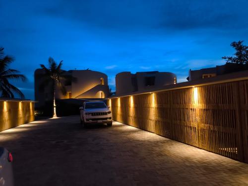 a white truck parked next to a fence at night at Casa Gaviota in La Majahua