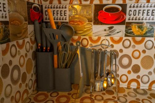 a kitchen counter with utensils in holders on a wall at Cabaña familiar con 2 dormitorios y baños privados in Villa de Leyva