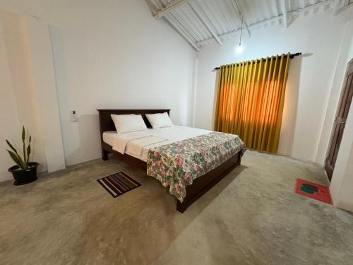 a bedroom with a bed in a room with a window at Sun Bird Villa in Elagawagoda
