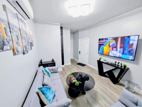 a living room with a couch and a table at Newly renovated luxury 3BR Condo! 30 mins to NYC in Jersey City