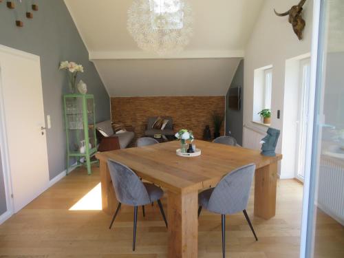 a dining room with a wooden table and chairs at FerienLoft Eifeel Good - Natururlaub in Monschau in Monschau