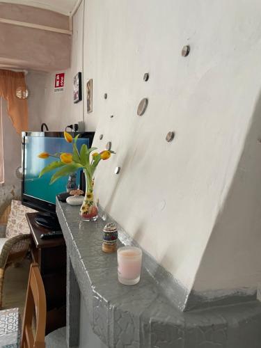 a room with a table with a rock wall at Rifugio nel cuore dell'Abruzzo in Carpineto Sinello