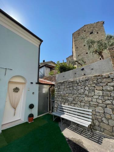 a stone wall with a bench next to a building at Rifugio nel cuore dell'Abruzzo in Carpineto Sinello