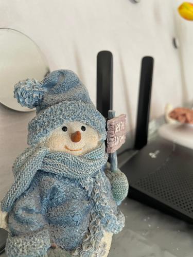 a stuffed snowman toy sitting on top of a laptop at Rifugio nel cuore dell'Abruzzo in Carpineto Sinello