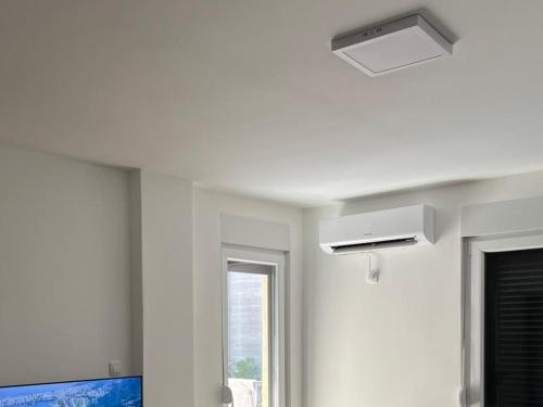 a bathroom with a ceiling fan and a window at Jelisej app in Prokuplje