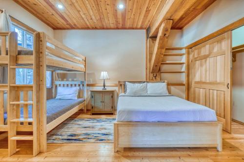 a bedroom with two bunk beds and a desk at Private Ranch 2BR Cabin Retreat Sleeps 9 in Anacortes