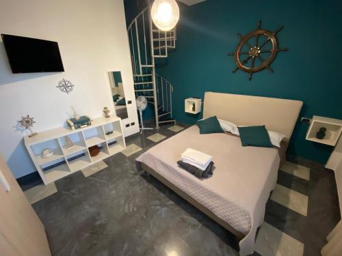 a bedroom with a bed with a wheel on the wall at La dimora del marinero in San Benedetto del Tronto