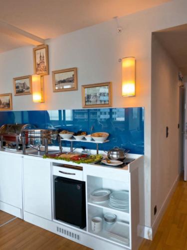 a kitchen with a counter with food on it at Orbi CIty Waterfront Aparthotel in Batumi