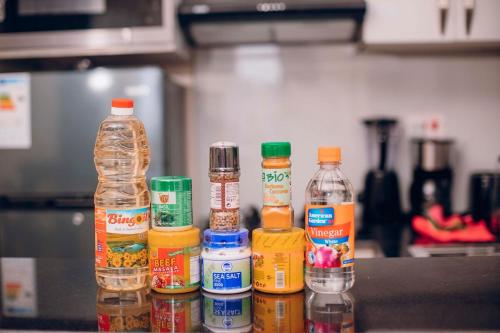 a group of bottles of food on a kitchen counter at Peaceful Nest Apartment in Kigali