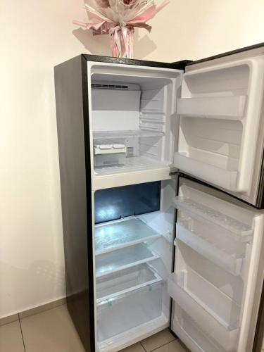 an empty refrigerator with its door open in a kitchen at Taman Equine comfy studio, high-end facilities in Seri Kembangan