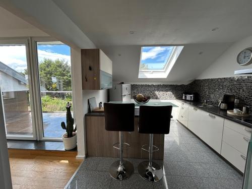 a kitchen with a counter and two stools at FerienLoft Eifeel Good - Natururlaub in Monschau in Monschau