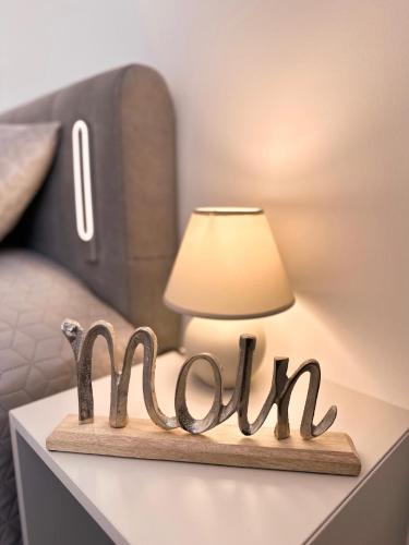 a wooden sign that says mum on a table next to a lamp at Ferienwohnung Seehund in Wilhelmshaven