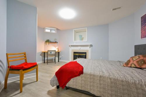 a bedroom with a bed and a chair and a desk at Stylish 2BR: w/free parking & streaming! in Pickering