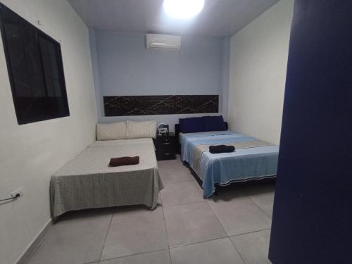 a room with two beds and a couch at Evolution Home in Astoria