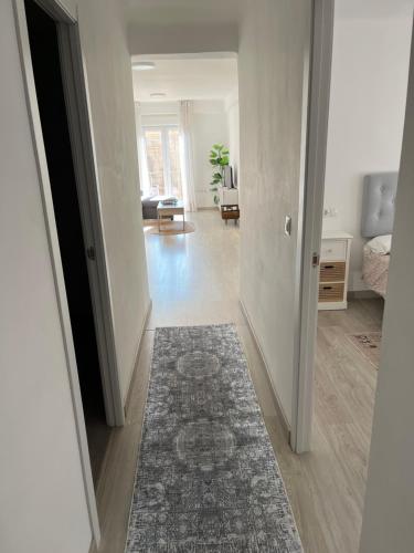 a hallway with a living room with a rug at PISO CENTRO CON VISTAS ANTEQUERa in Antequera