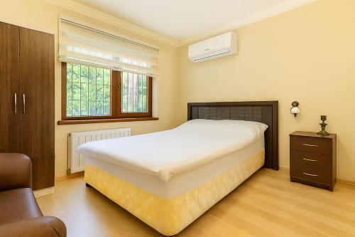 a bedroom with a large white bed and a window at 34 Yüksel Garden in Ankara