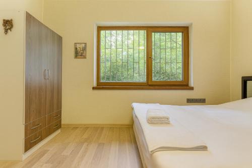 a bedroom with a bed and a window at 34 Yüksel Garden in Ankara