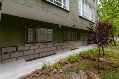 a green building with windows on the side of it at 34 Yüksel Garden in Ankara