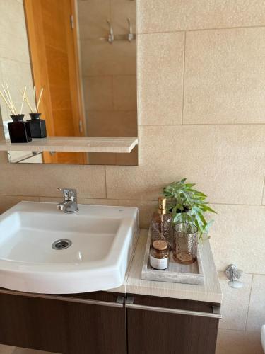 a bathroom with a sink and a mirror at WAY R ST Sweet home in Gran Tarajal