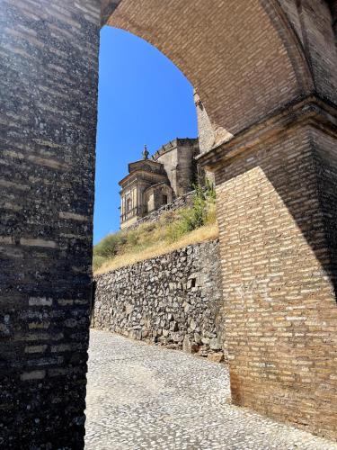 a building on top of a stone wall at Apartamentos Principado de Aracena II in Aracena