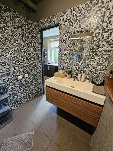 a bathroom with a sink and a mirror at Oasis in Ventspils