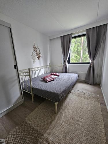 a bedroom with a bed in front of a window at Studio Ski Lodge in Rovaniemi