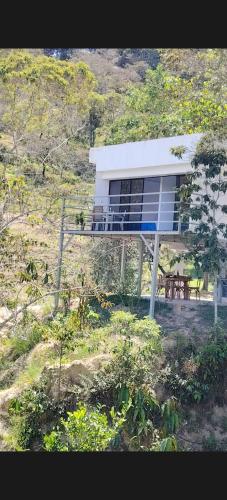 a house on a hill with a table in front of it at Villas Entre Lagos in Lebrija
