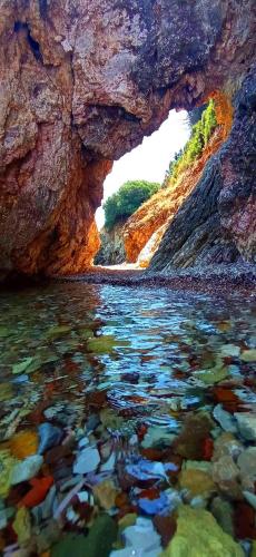 a view of a body of water in a cave at ThalaSEA Apartments in Chrani