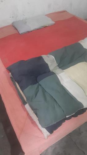two beds are shown on a red table at Aitco Enterprise 