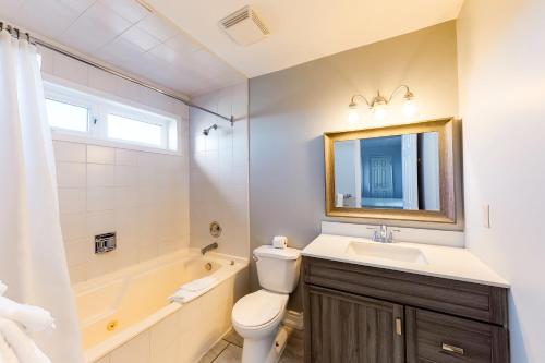 a bathroom with a sink and a toilet and a tub at Wintergreen 223 in Blue Mountains