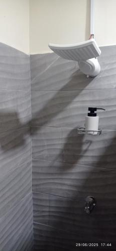 a person walking in a bathroom with a shower at Estancia WLC in Ayutuxtepeque