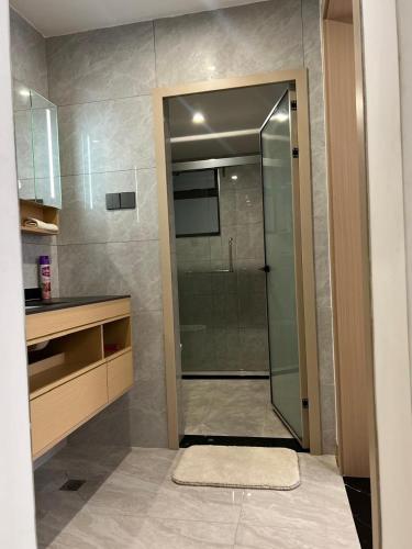 a bathroom with a shower with a glass door at Paradise Haven in Nairobi