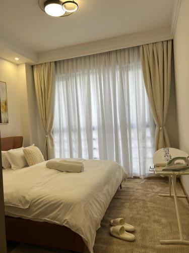 a bedroom with a bed and a window with a phone at Paradise Haven in Nairobi