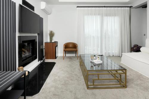 a living room with a couch and a glass coffee table at Didi Hotel Sapanca in Sapanca
