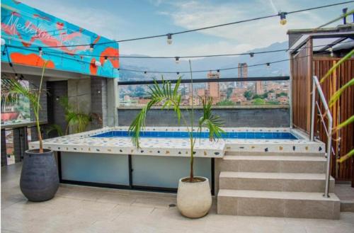 a hot tub on top of a building with plants at BOHÍO del Pescador Barquero - Diverso y con Alma in Medellín