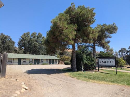 a motel sign and a tree in front of a building at Squaw Valley Motel Room #1 in Squaw Valley