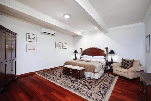 a bedroom with a bed and a couch and a chair at Terra Nova, BW Premier Collection in Kingston