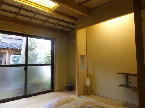Postel nebo postele na pokoji v ubytování Guesthouse Mikkaichi