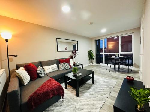 a living room with a couch and a table at Stylish 2BR Stay- Preston City in Preston