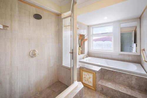 a bathroom with a bath tub and a window at Terra Nova, BW Premier Collection in Kingston
