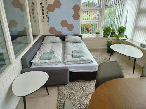 a living room with a couch and two tables at Family-friendly house in Holluf Pile in Odense