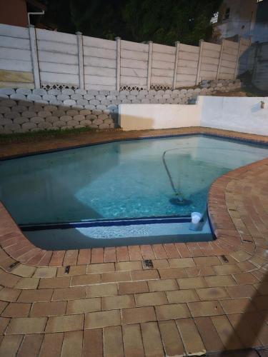 a swimming pool with a golf ball in it at Charming Cottage for Getaways in Empangeni