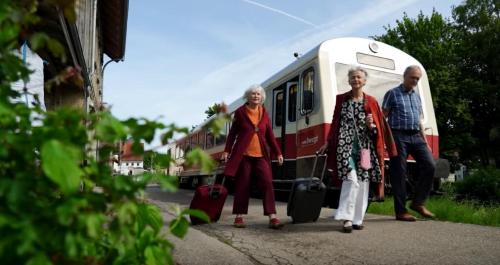 a group of people standing in front of a train at Gästehaus am Sternberg in Gomadingen