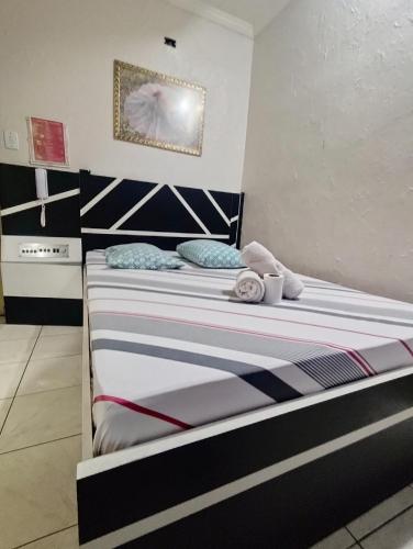 Ένα ή περισσότερα κρεβάτια σε δωμάτιο στο Hotel talismã