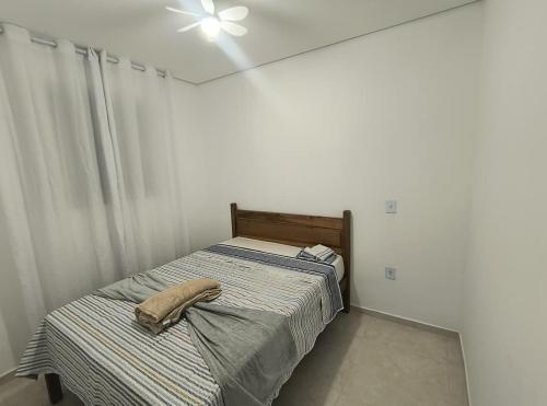 a bedroom with a bed with a hat on it at Recanto da Totô in Paraty