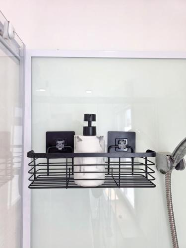 a shelf with two items on it in a bathroom at Le Velours, Cosy & Raffiné avec Parking in Saint-Brieuc