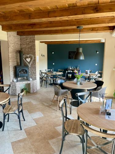 a restaurant with tables and chairs and a fireplace at Apartmán v Šenku 